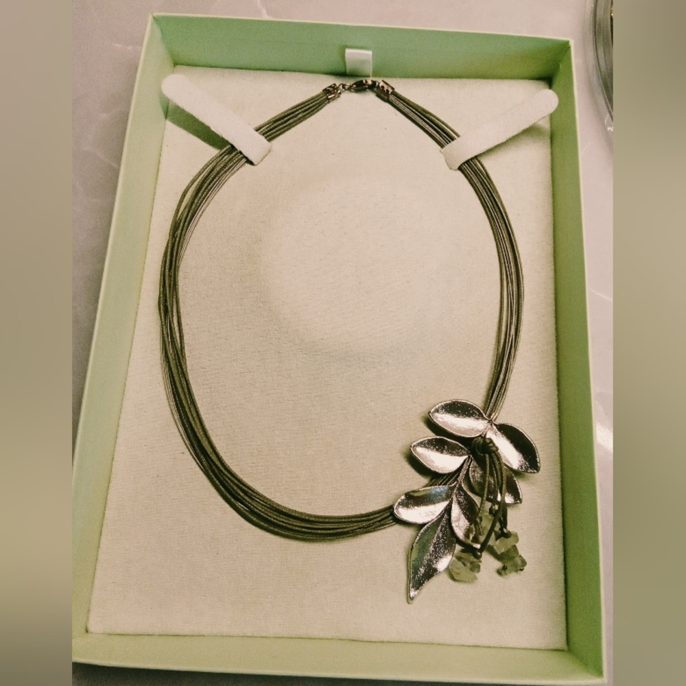 Beautiful one of a kind statement necklace. 12 strands  with olive leaf pendant.